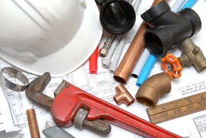 Plumbing parts, tools, and plans used by Gary's Plumbing, Inc..